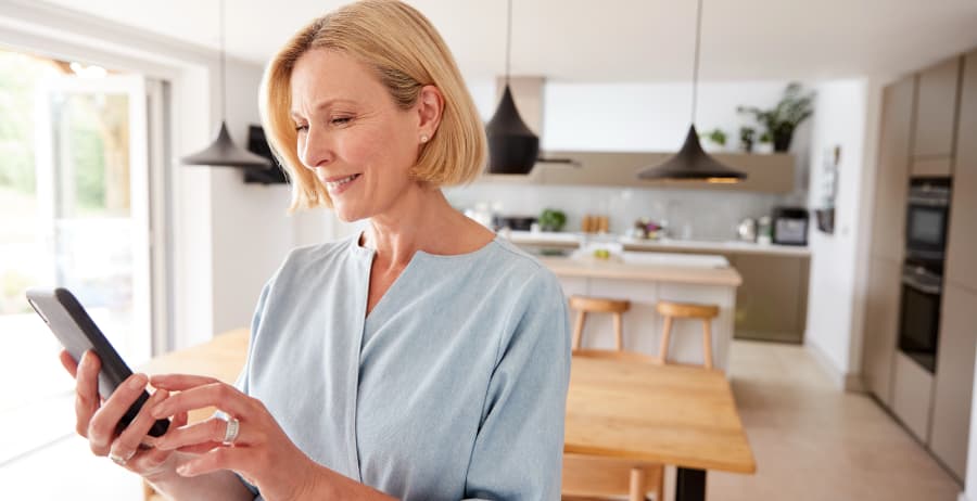 Woman using a cell phone in a stylish home